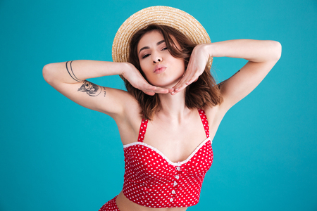 Beauty woman posing in studio and looking at the camera over blue backgroundの写真素材