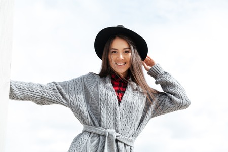 Cheerful woman smiling with teeth while walking in the streetの写真素材