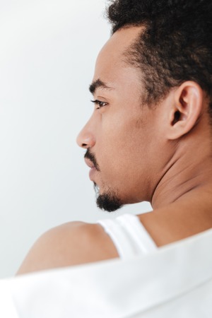 Photo of serious young african man isolated over white background. Looking aside.の写真素材