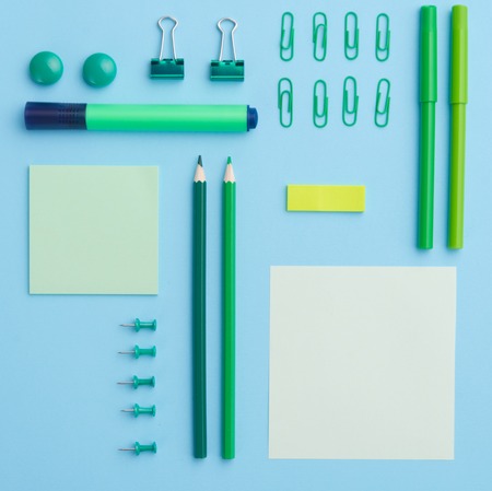 Top view image of office supplies on the blue background tableの写真素材