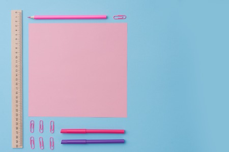 Top view image of office supplies on the blue background table