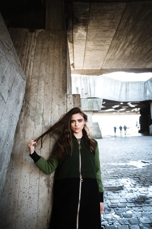 Image of beautiful young woman standing and posing outdoors. Looking at camera.の写真素材