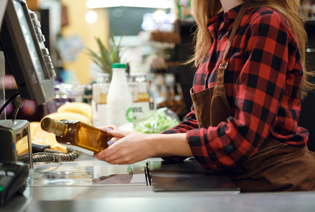 Cropped photo of cashier lady on workspace in supermarket shop.の写真素材