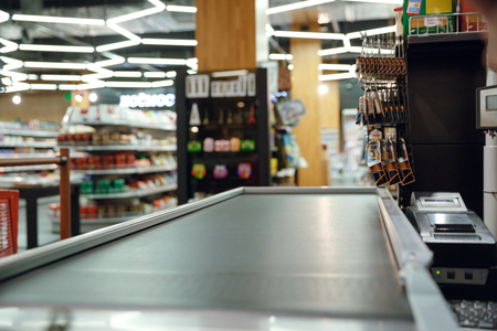 Cropped picture of cashier's desk in supermarket shop