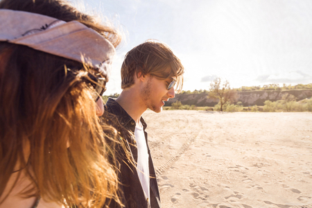 Side view of a young couple walking on a beach togetherの写真素材