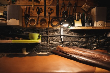 Picture of instruments on wooden wall at footwear workshop.の写真素材