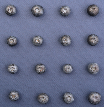 Top View Image of blueberries isolated over blue background table.