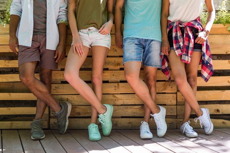 Cropped picture of young multiethnic friends students standing outdoors.の写真素材