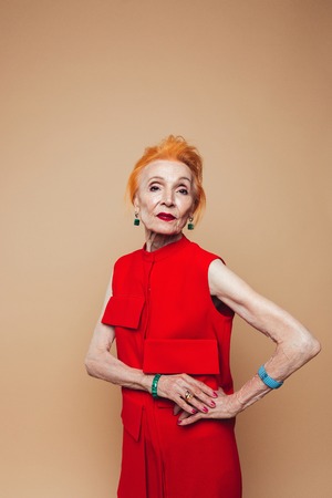Image of amazing mature redhead fashion woman standing isolated at studio and posing. Looking camera.の写真素材