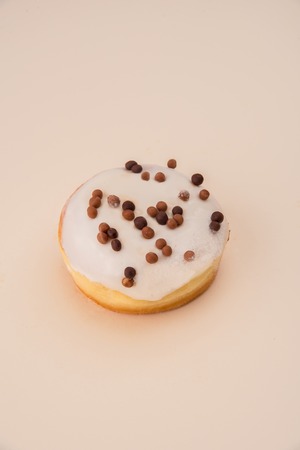 Shot of delicious donut with white cream and flakes isolated over whiteの写真素材