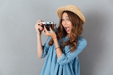 Picture of smiling young caucasian woman photographer holding camera.の写真素材