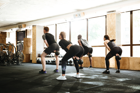Image of sports group of people make sports exercise with weight indoors.の写真素材