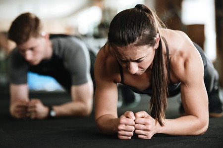 Image of group of multiethnic sports strong people make sport exercises in gym.の写真素材