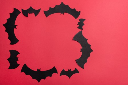 Traditional haloween symbols of black bats on red background. Haloween picture and frame for logoの写真素材