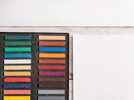 Box with colorful pastel paint isolated on white paperの写真素材