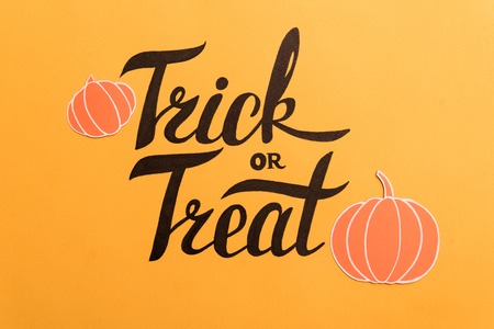 Haloween theme phrase in frame of pumpkins and bats on orange backgroundの写真素材