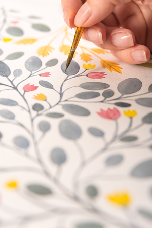 Close up of different colorful flowers nature design painted with brush and watercolors on paperの写真素材