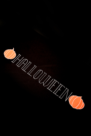 White typeface text for halloween logo handwritten on black background. Traditional symbols of pumpkinsの写真素材