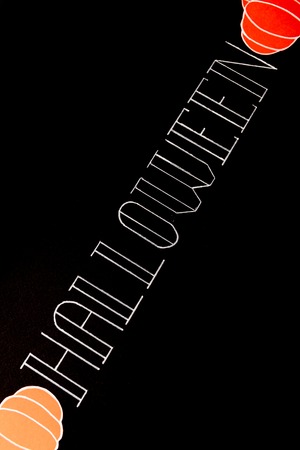 White typeface text for halloween logo handwritten on black background. Traditional symbols of pumpkinsの写真素材