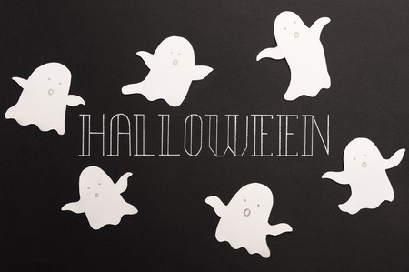 White typeface text for halloween logo handwritten on black background. Traditional symbols of ghostsの写真素材