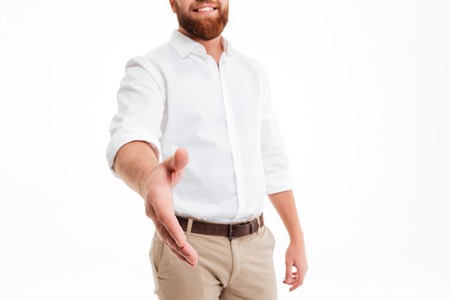 Cropped image of a smiling bearded man greeting someone with his hand isolated over white backgroundの写真素材