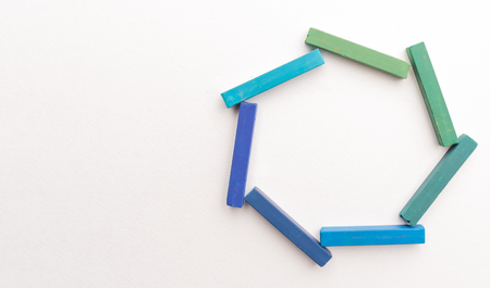 Close up of colorful chalks in geometric composition, isolated on white backgroundの写真素材