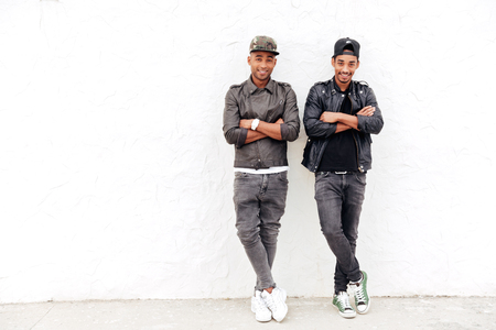 Image of handsome two young african men friends standing outdoors. Looking camera.の写真素材