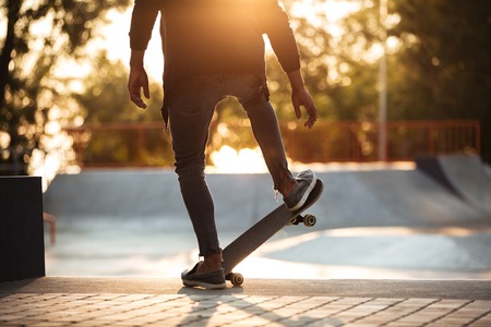 Young african man doing skateboarding outdoor in a skate parkの写真素材