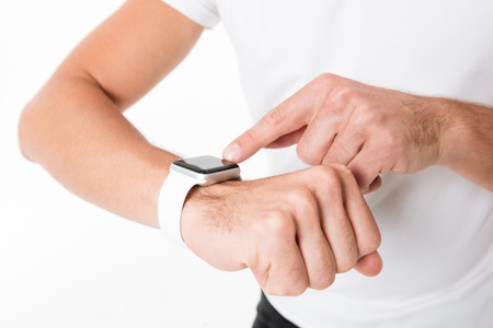 Close up portrait of a male hands pointing finger at smart watch isolated over white background