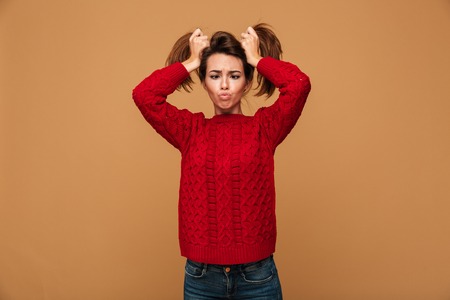 Image of pretty caucasian woman dressed in sweater standing isolated showing funny emotions.の写真素材