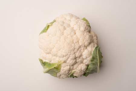 Close up of a ripe cauliflower isolated over white backgroundの写真素材