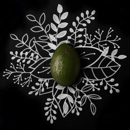 Avocado over outline floral hand drawn backgroundの写真素材