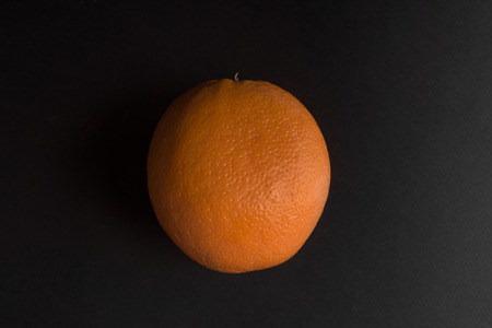 Fresh orange fruit isolated over black backgroundの写真素材