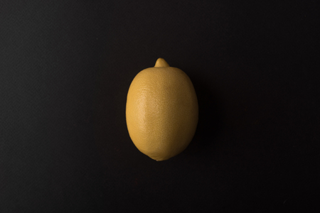 Fresh lemon isolated over black backgroundの写真素材