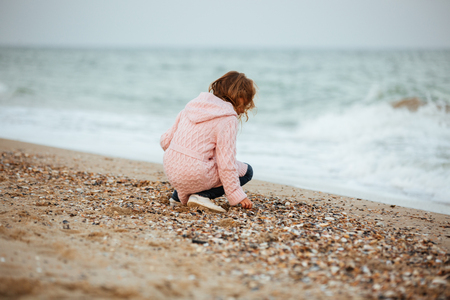 Cute little girl playing on the beachの写真素材