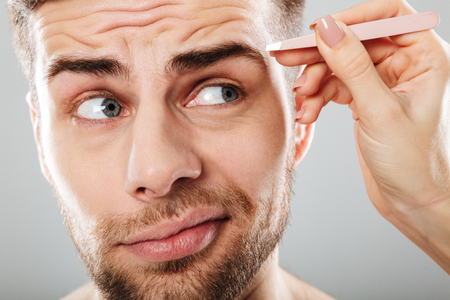Close Up Portrait Of Female Hand Plucking Young Men S Eyebrows