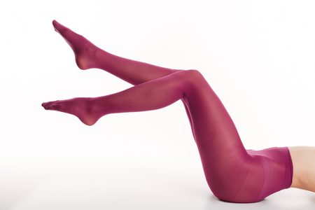 Cropped image of sexy lady in elegant colorful tights isolated over white background.の写真素材