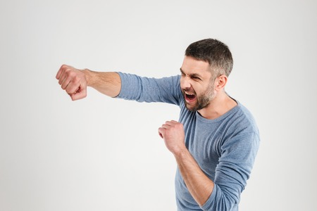 Image of handsome man boxing isolated over white background wall. Looking aside.の写真素材