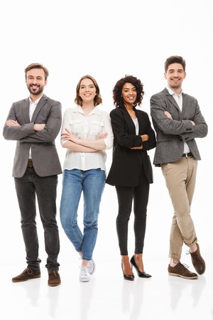 Full length portrait of a group of happy multiracial business people standing with arms folded...