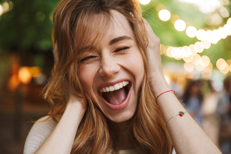 Close up of happy young girl screaming while standing at the parkの写真素材