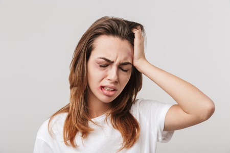 Image of a sad disabled young girl with scratches and bruises on her face.の写真素材