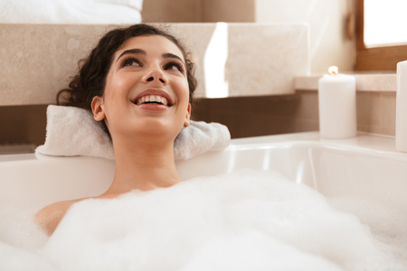 Image of young cute pretty woman in bathroom lies resting in bath.の写真素材
