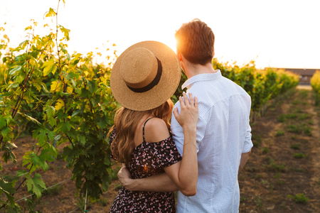 Back view image of young cute loving couple outdoors hugging with each other.の写真素材