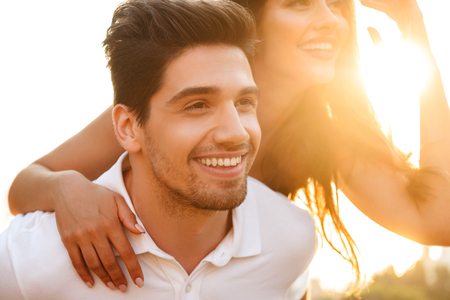 Photo of cute happy young loving couple walking outdoors having fun.の写真素材