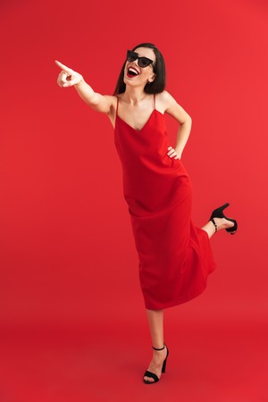 Image of amazing emotional young beautiful woman posing isolated pointing.の写真素材