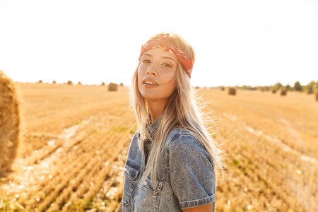 Attractive young blonde girl in headband at the wheat fieldの写真素材