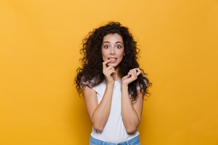 Image of amazing excited young cute woman posing isolated over yellow background.の写真素材