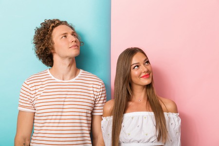 Portrait of a smiling young couple looking up