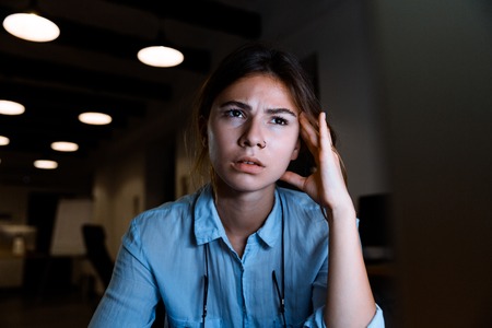 Concentrated young woman designer sitting in the officeの写真素材