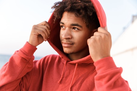 Image of a young sports guy outdoors on the beach looking aside.の写真素材